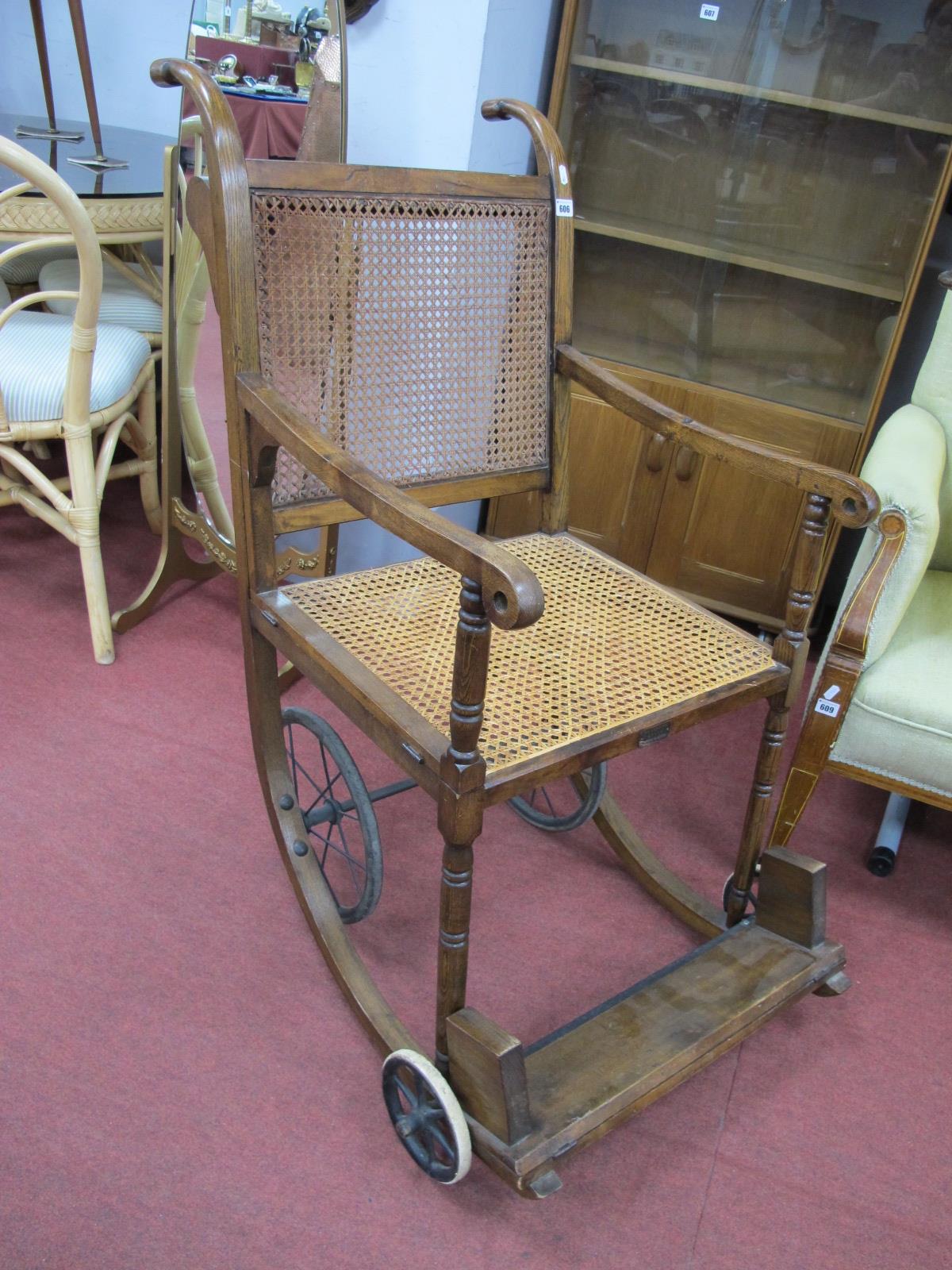 An Ealry XX Century Patient/Invalid Hospital Chair, cane seat and back, folding front foot rest