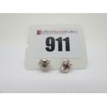 A Pair of Modern Single Stone Morganite Earstuds, oval four claw set, stamped "925".