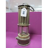 The Premier Lamp of Leeds Miners Lamp, having vertical ribbed upper body, 27cm high with