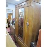 1930's Oak Double Wardrobe, with carved panels flanking mirrored door over single drawer, approx