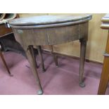 An Oak Fold Over Tea Table, of demi lune form with lift-up top, 76.5cm diameter, on tapering legs