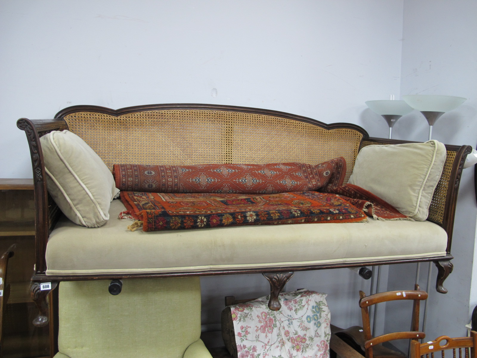 Early XX Century Mahogany Settee, with shaped back rail, carved scroll hand rests and shell motifs