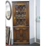 Bevan Funnell Reprodux Oak Freestanding Corner Cupboard, with upper leaded glazed door.