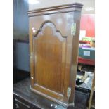 A XIX Century Oak Corner Wall Cabinet, with shaped moulding to single door, three inner shelves,