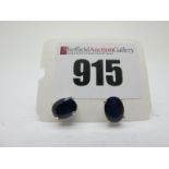 A Pair of Modern Single Stone Sapphire Earstuds, oval four claw set, stamped "925".