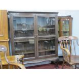 A 1920's Oak Display Cabinet, with low back, carved horizontal band to twin glazed doors, on