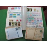 A Collection of Mint and Used Saarand East German Stamps, mainly in sets in a green stockbook.