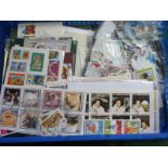 A Collection of World Stamps, mint and used in an album, plastic bags and loose. Many hundreds to
