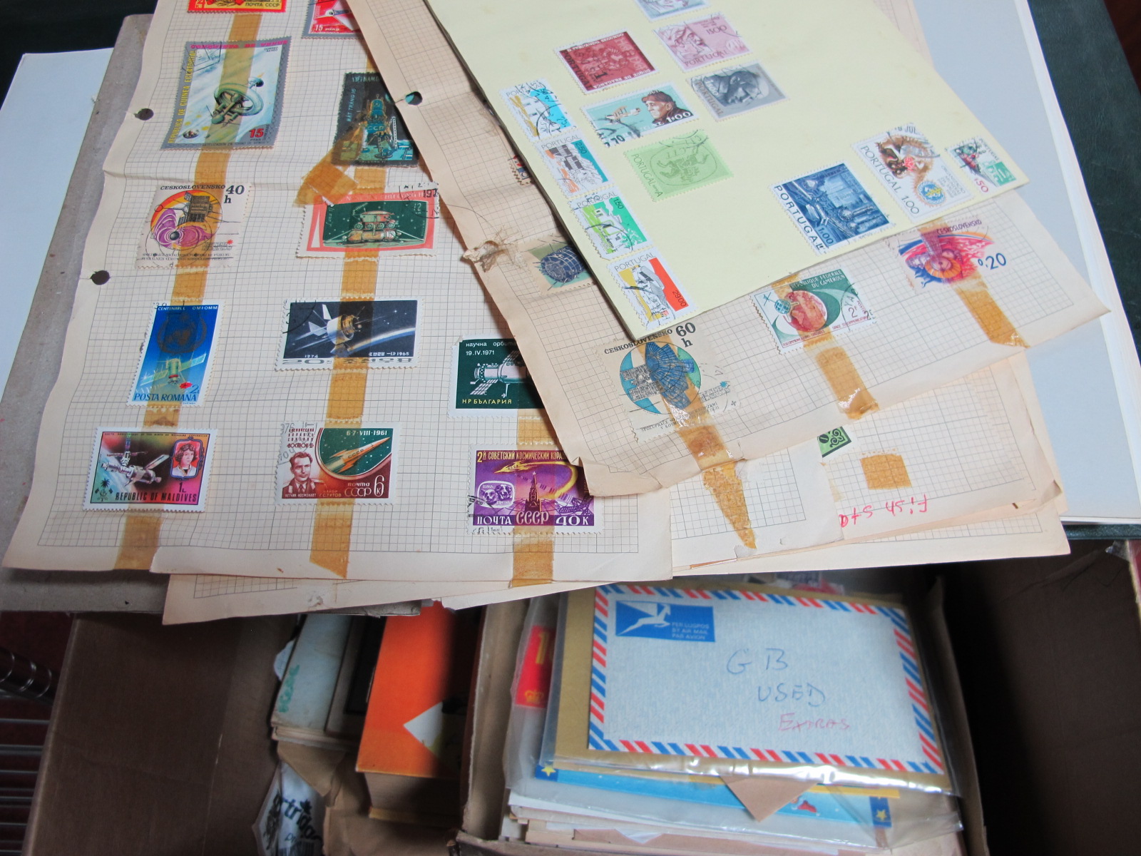 A Box Containing an Accumulation of GB and World Stamps in an Album, in packets and on album