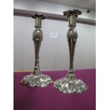 A Pair of Decorative Continental Style Plated Candlesticks, each of sinuous design, with removable