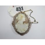 A Large Shell Carved Cameo Brooch, collet set with openwork decorative border, stamped "9ct".