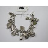 A Hallmarked Silver Curb Link Charm Bracelet, to heart shape padlock clasp, suspending novelty