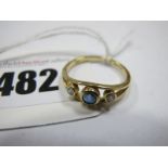 An 18ct Gold Sapphire and Diamond Three Stone Ring, graduated collet rubover set, between bifurcated