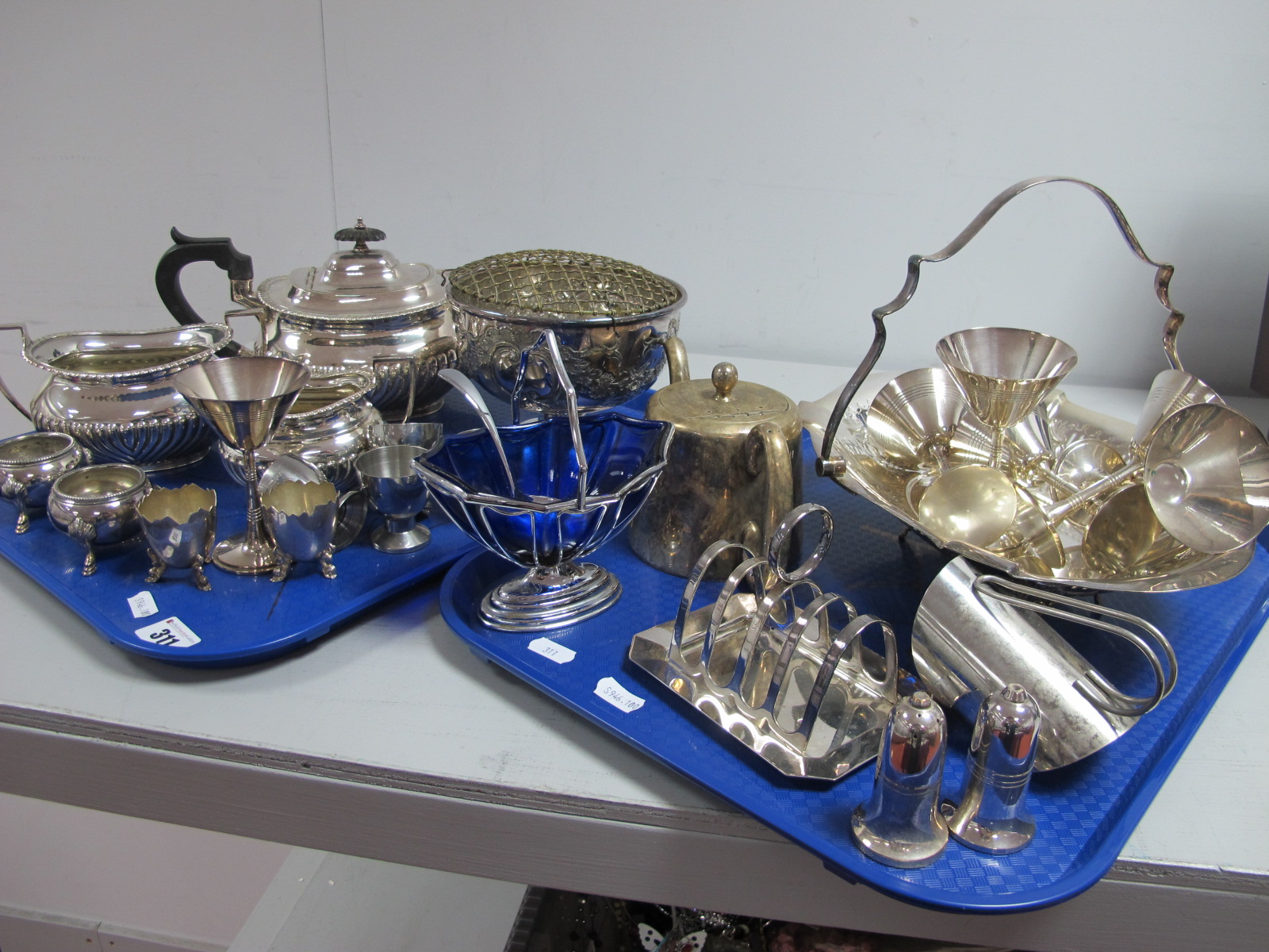 A Mappin & Webb Plated Three Piece Tea Set, a plated swing handled dish, set of goblets, a toast