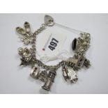 A Hallmarked Silver Curb Link Charm Bracelet, to heart shape padlock clasp, suspending novelty