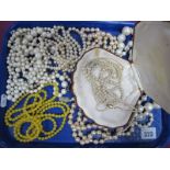 A Long Graduated Single Strand Imitation Pearl Necklace, to oval clasp stamped "9ct", further