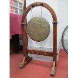 A Late XIX Century Dinner Gong, 31cm diameter suspended from an arched mahogany stand, 88cm high