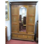 A 1930's Oak Wardrobe, having Fluer De Lys panels, flanking mirrored door, on drawered base, 122cm