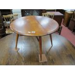 Ercol Coffee Table, with single drop leaf to circular top on splayed tapering legs, 60cm diameter.