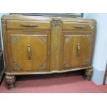 A 1930's Oak Sideboard, with low back, concave reeded centre section of angular front, twin