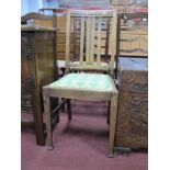 A Set of Four Early XX Century Oak Dining Chairs, with rail backs on square pad feet.