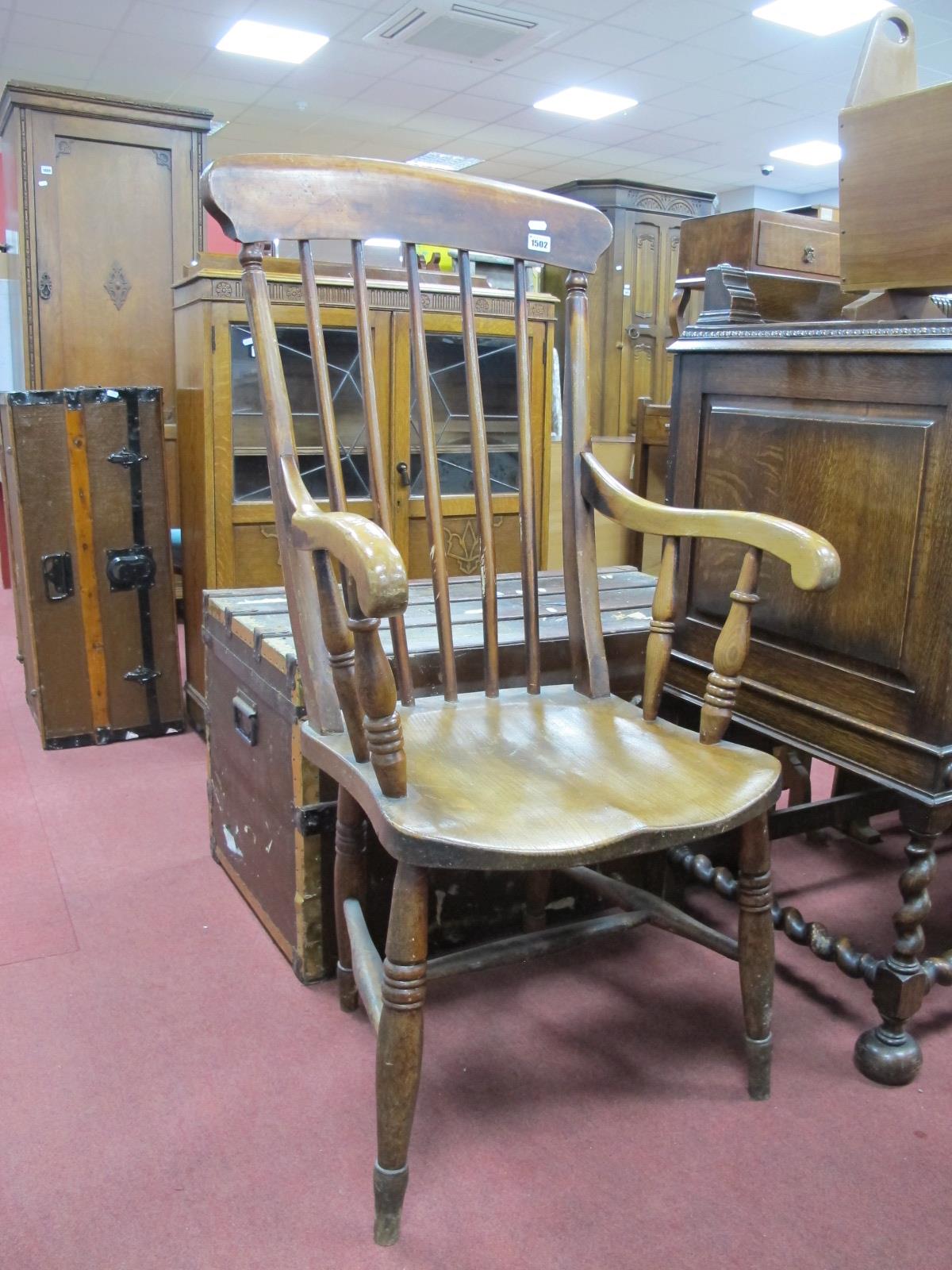 A XIX Century Stained Pine Farmhouse Kitchen Armchair, with spindle back on turned legs.