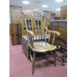 A XIX Century Stained Pine Farmhouse Kitchen Armchair, with spindle back on turned legs.