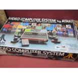 Atari Video Computer System CX-2600, with game programmes, 'Defender', 'Pac-Man', 'Demons to