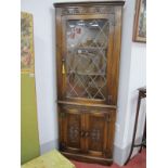 Bevan Funnell Reprodux Oak Freestanding Corner Cupboard, with upper leaded glazed door.