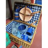 A Wicker Picnic Hamper, with plastic mugs, plates etc.