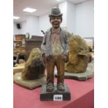 An Early XX Century Carved Musical German Figure of a Gentleman wearing a bowler hat and dicky