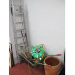 A Garden Hose, garden tools, wheel barrow, step ladder, terracota planter.