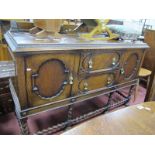 1920's Oak Sideboard. in the Jacobean manner, having low back, twin drawers flanked by cupboard