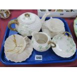 Belleek Basket Work Teapot, milk jug, dish, two cups (one damaged) and two saucers, all black back