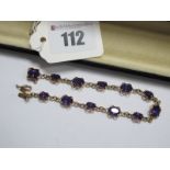 A 9ct Gold Amethyst Set Bracelet, graduated oval claw set throughout, to snap clasp, overall