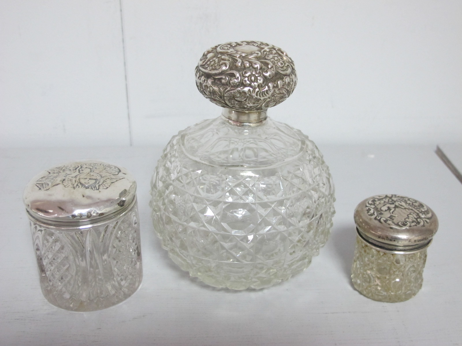 A Large Hallmarked Silver Topped Globular Glass Scent Bottle, London 1901; together with two