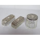Two Hallmarked Silver Lidded Glass Dressing Table Pots, each detailed in relief with leaf scrolls;