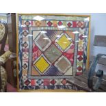 Framed Quilt, with embroidery to central lozenge panels, 91 x 101cm.