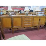 A Teak Sideboard, with four central drawers flanked by four cupboard doors having lipped handles