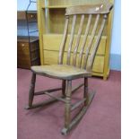 A XIX Century Ash/Elm Fireside Rocking Chair, with rail supports, on turned legs, H stretcher, on