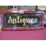 A Hand Painted Barge Ware Style "Antiques" wooden sign, 34.5cm wide.