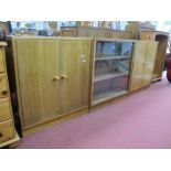 Two Teak Cabinets; together with a glazed bookcase.