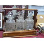 Oak Tantalus, with brass carry handle, three various glass decanters to slide out drawer (no key).