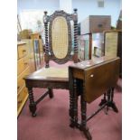 An Edwardian Mahogany Sutherland Table, with canted corners to drop leaves, on turned supports. a