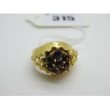 A Highly Decorative Dome Style Dress Ring, with a claw set flower head cluster centre, between