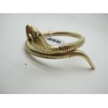 A Modern 9ct Gold Snake Style Bangle, textured finish, with inset eyes, stamped "Steel Spring" (