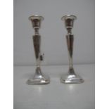 A Pair of Hallmarked Silver Candlesticks, Chester 1913, each of plain tapering form on square