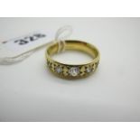 An 18ct Gold Diamond Set Band, the uniform band star set with fine graduated old cut stones, (finger