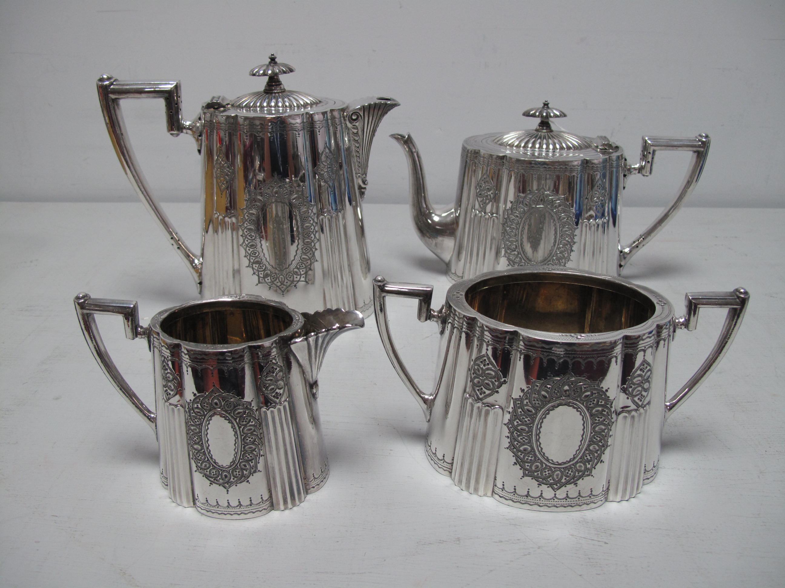 An Electroplated Four Piece Tea Set, each of fluted tapering oval form, with vacant oval