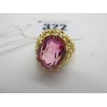 A Fancy High Set Dress Ring, with large oval claw set centre, within openwork textured setting,